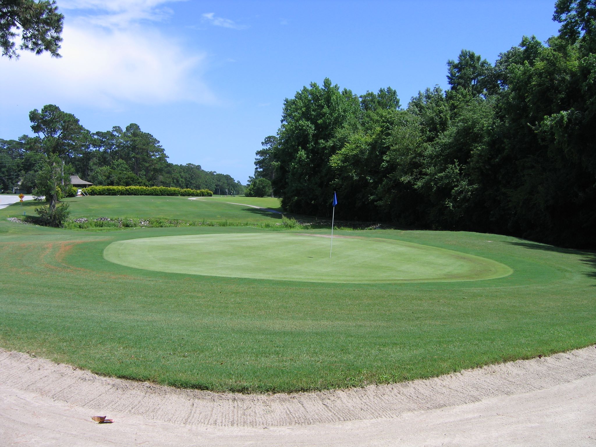 Image of golf ball on tee on grass.